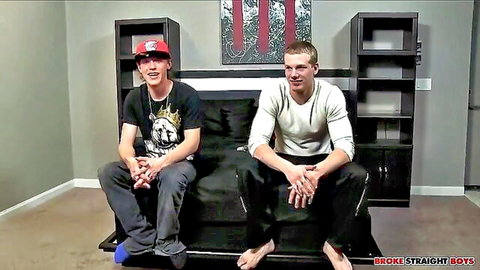 Johnny Forza and Duncan Tyler on couch in casual clothes, muscular gay duo preview