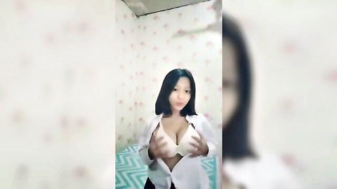 Asian amateur girl squeezing big tits in open white shirt and bra