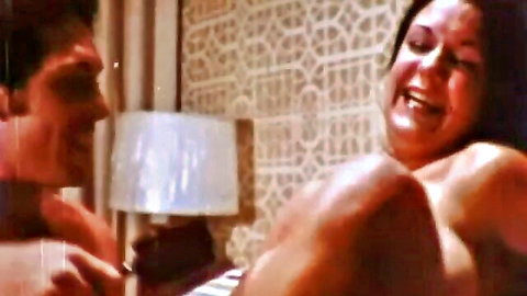 Vintage couple in intimate topless embrace from classic XXX film