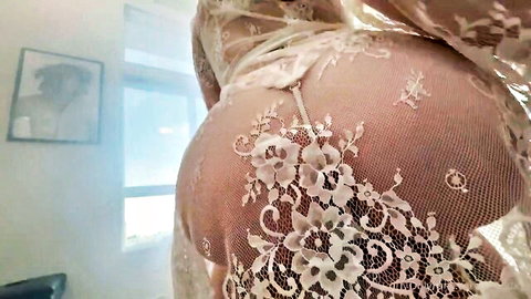 Melody Marks in sheer lace lingerie, teasing her curves from behind