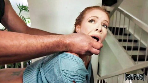 Redhead teen's mouth pried wide open by rough hand grip in intense face fuck scene on stairs