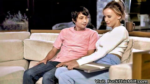 Blonde MILF stepmom flirts with stepson on couch holding laptop intimately