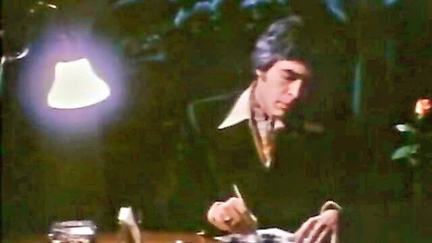 Vintage 1975 porn scene: suited man writing at desk in The Story of Joanna