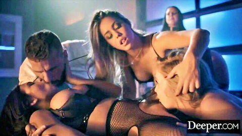 Brunette in fishnet lingerie kissing muscular guy as blondes grope him in steamy orgy