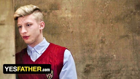 Blonde twink in school uniform sweater vest pouting seductively for gay priest roleplay.