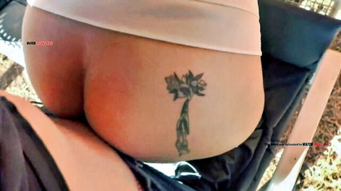 Mila Hase exposes tattooed big ass outdoors in teasing pose
