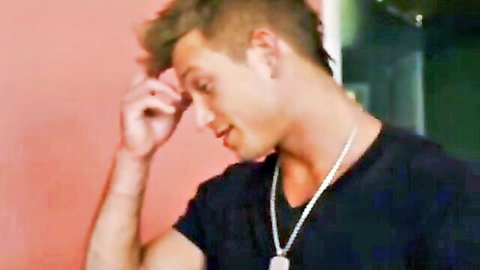 Tanner Mayes seductive pose in black tank top with piercings, bedroom scene