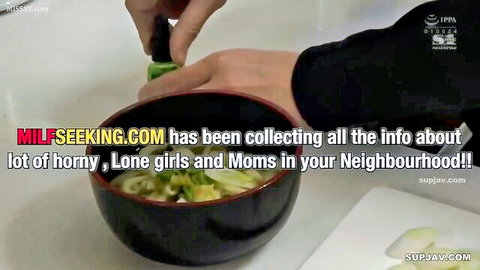 Hands in black sleeves using chopsticks to grab noodles and veggies from black bowl with supjav watermark