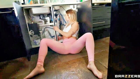 Blonde Tina Snows in tight pink leggings squatting provocatively under sink