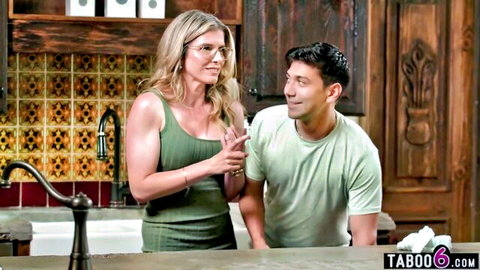 Blonde stepmom in green dress chatting with stepson, taboo tease