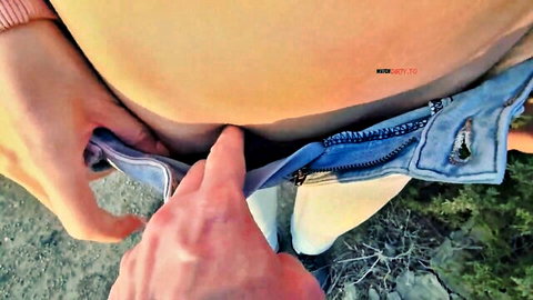 Man's hand unzipping girl's tight jeans outdoors exposing smooth pubic mound tease