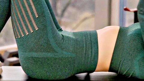 Babe in tight green leggings arches her juicy ass up on gym bench