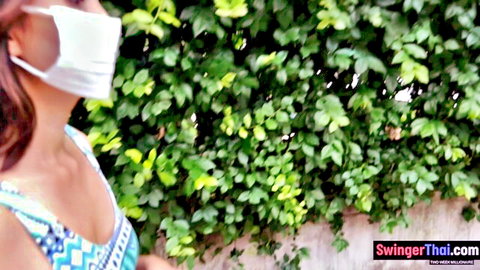 Thai woman in cleavage top and mask outdoors after coffee date