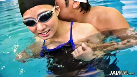 Petite Japanese swimmer in blue swimsuit kissed intimately in pool