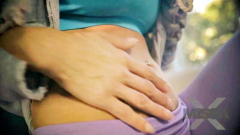 Alexis Fawx sensual midriff caress in teal top and purple pants