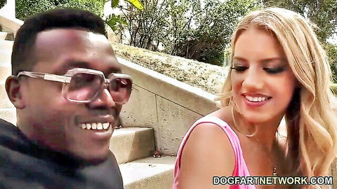 Blonde white girl smiles flirtatiously at black stud in sunglasses on outdoor steps