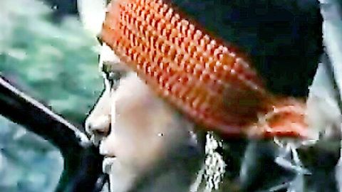 Seductive retro brunette teen with orange headband and hoop earrings in profile close-up