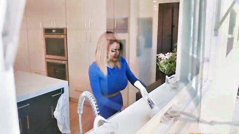 Blonde MILF in tight blue bodysuit bends over kitchen sink scrubbing teasing her ass
