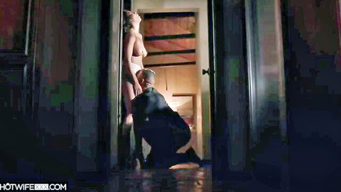 Brunette with big tits leans naked against door as man kneels eating her pussy intensely