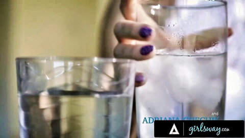 Adriana Chechik with purple nails holding water glass in Girlsway scene