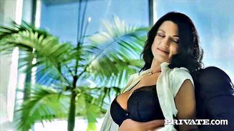 Ania Kinski in seductive black lace bra and open white blouse, deep cleavage
