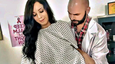 Curvy brunette patient in open hospital gown groped by bearded doctor in medical exam room