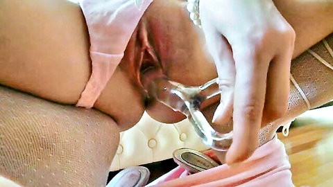 Solo babe pulls pink panties aside inserting clear speculum into shaved pussy closeup