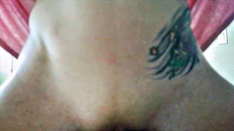 Closeup of shaved MILF pussy lips exposed with red panties pulled aside and colorful feather tattoo on hip