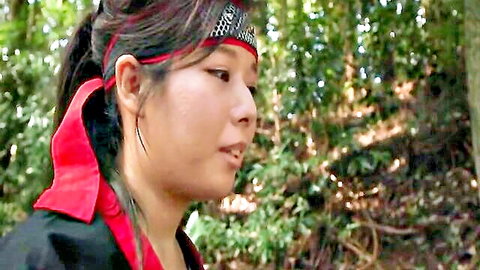 Asian JAV star with black ponytail and red headband in forest outdoors