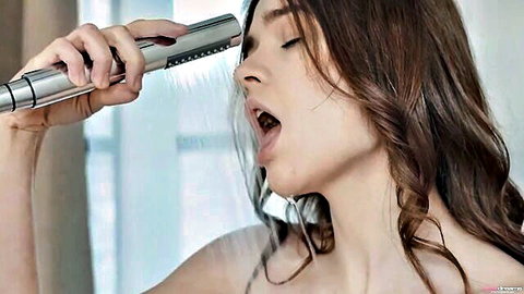 Super hot babe in steamy shower, holding showerhead close, wet and seductive