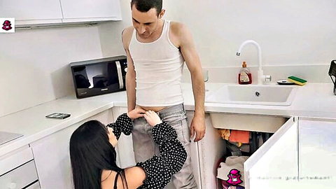 Didi Zerati kneeling, seducing plumber by pulling down his pants
