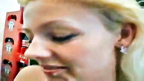 Closeup of smiling blonde woman in red locker room with diamond earrings