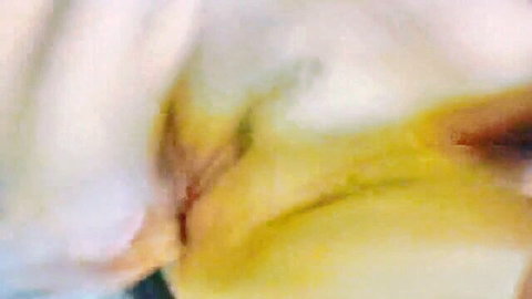 Closeup of fair-skinned amateur's shaved pussy penetrated by thick yellow dildo