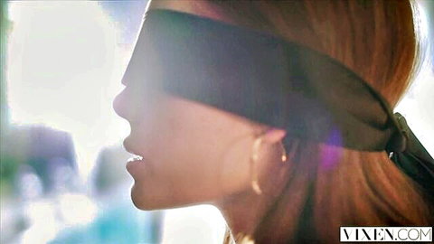 Blindfolded redhead beauty in profile with parted lips teasing blowjob fantasy