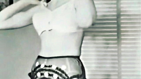 Vintage big bust blonde in sheer lingerie posing seductively