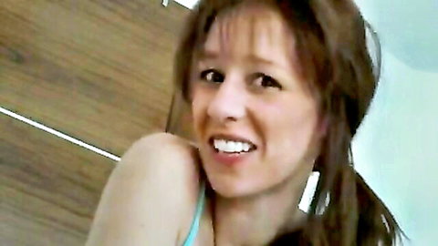 Smiling brunette MILF housewife in tight blue tank top solo tease