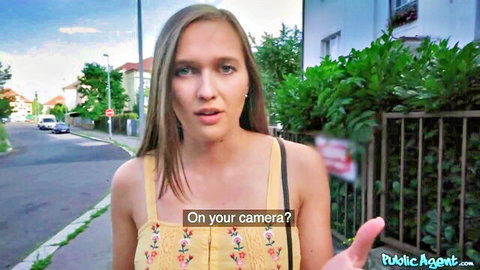 Slim blonde in yellow tank top surprised outdoors on street during public pickup asking on your camera