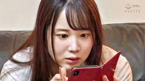 Young Asian woman in white top holding red phone case, intense gaze from aphrodisiac video