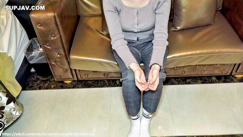 Clothed Asian amateur woman sitting casually in gray sweater and jeans