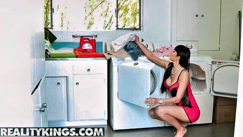 Eva Karera in pink lingerie squatting seductively by washing machine