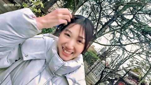 Smiling Asian woman in puffy white jacket outdoors, amateur JAV thumbnail