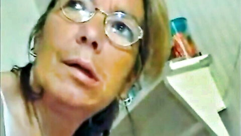 Mature blonde granny with glasses in amateur blowjob scene