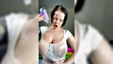 Tattooed busty amateur pours liquid on huge wet tits in see-through top
