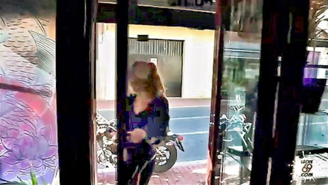 Blonde babe in tight pants showing off ass outside studio with motorcycle