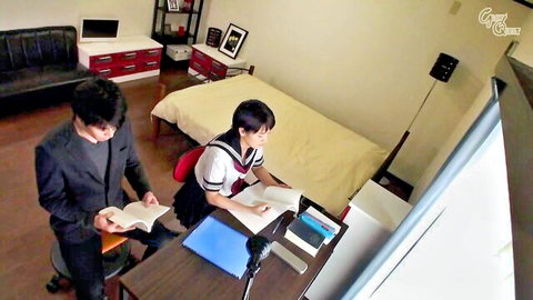 Ai Mukai in school uniform reading book with suited man in intimate study scene