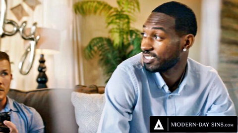 Handsome black stud smiles seductively at white guy on couch in gay interracial tease