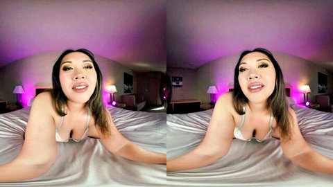 Asian beauty with big tits in low-cut lingerie smiling teasingly on bed POV