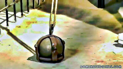 Older blonde subjected to metal bondage cage punishment outdoors