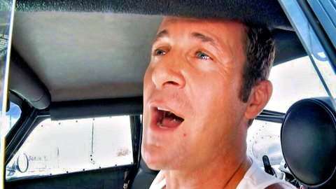 Amber Jayne in intense AR YHGB AIE gangbang scene, male performer shouting in car