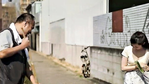 Japanese wife in floral dress talking to neighbor outdoors
